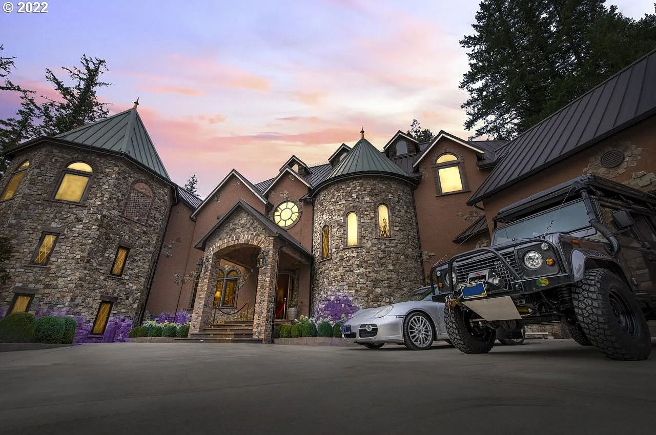 an exterior shot of a huge, castle-like home complete with turrets