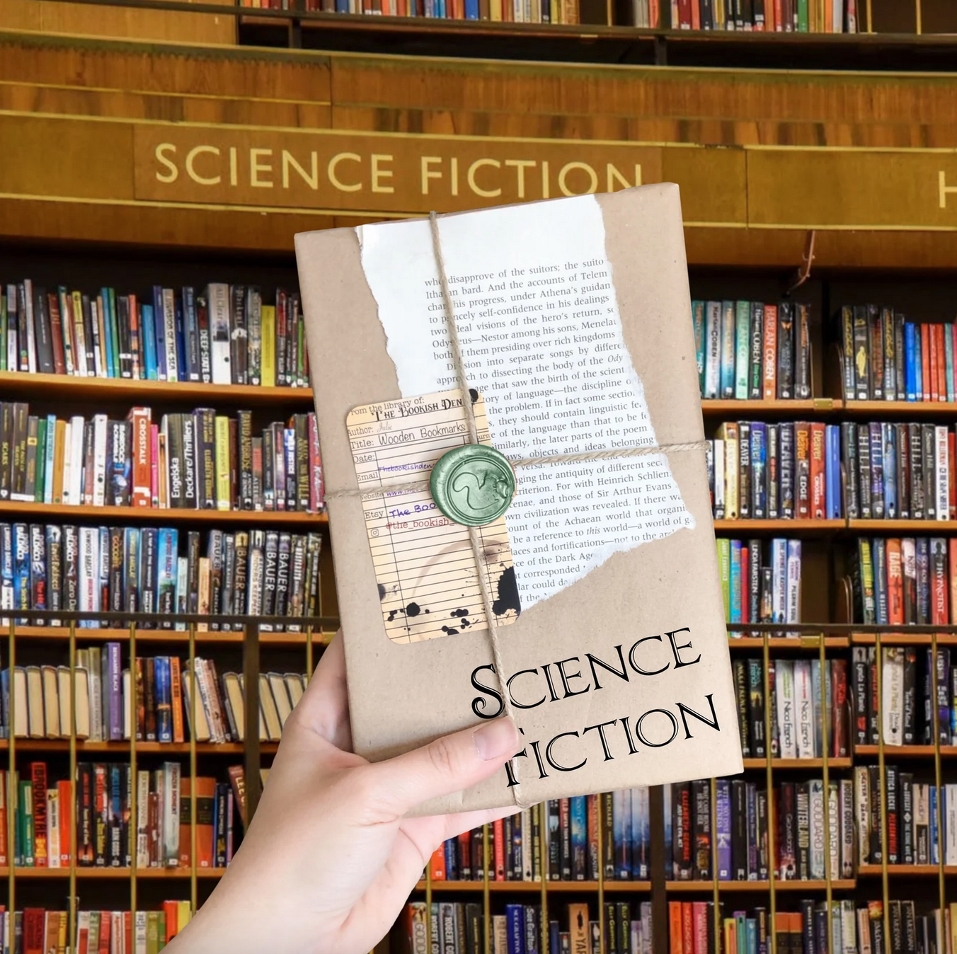 A hand holding a book wrapped in brown paper that says "science fiction"