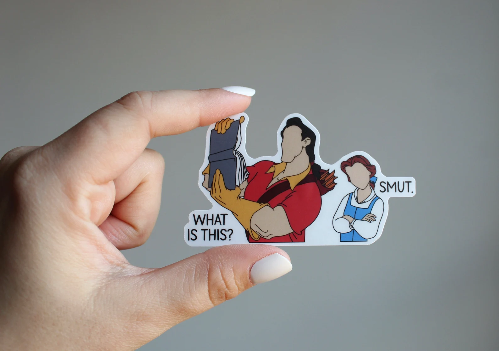 a sticker of Gaston holding up a book and asking "What is this?" and Belle responding, "Smut."