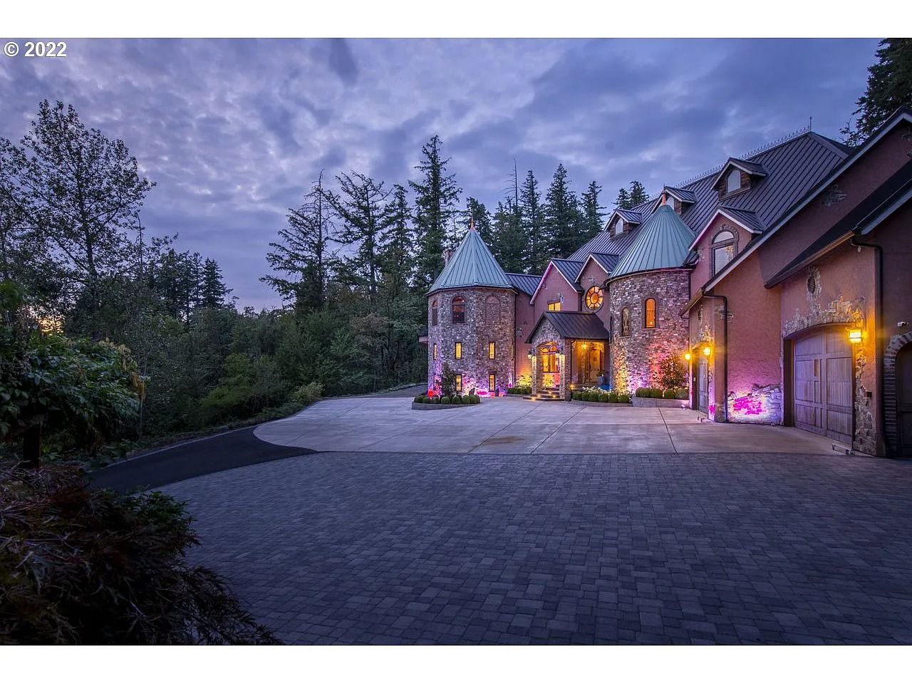 a photo of the castle-style home at night