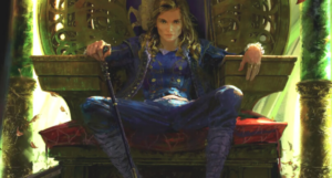 a cropped cover of The Faithless, showing an illustration of white woman slouched in a throne, holding a cane. She is making eye contact with the viewer.