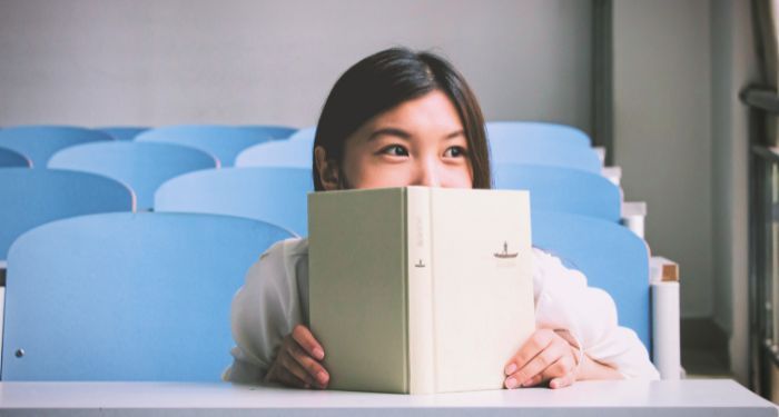 Image of an Asian woman with a book