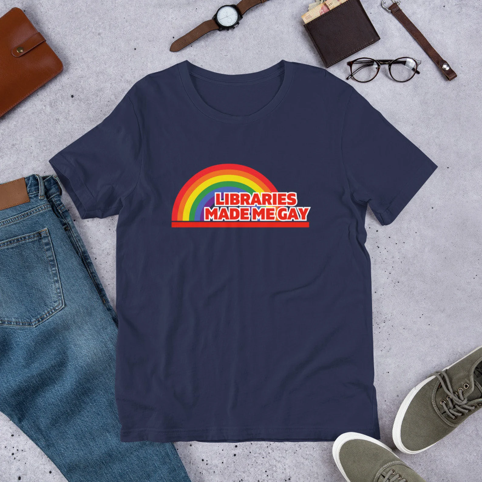 A navy t-shirt depicting a rainbow and the words "Libraries made me gay."