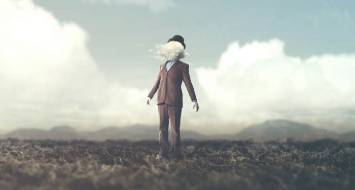 an image of a person wearing a suit, with a cloud where their head should be