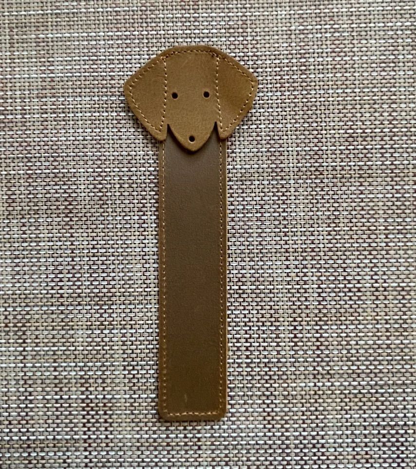 Image of a brown leather bookmark with a dog's head. 