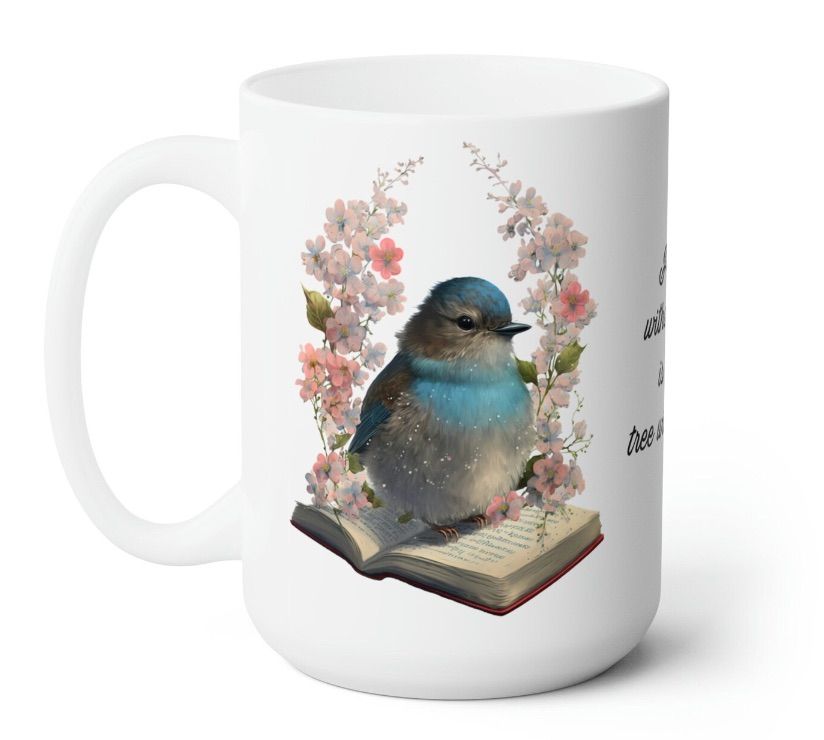 Image of a mug featuring a bluebird sitting on a book. 