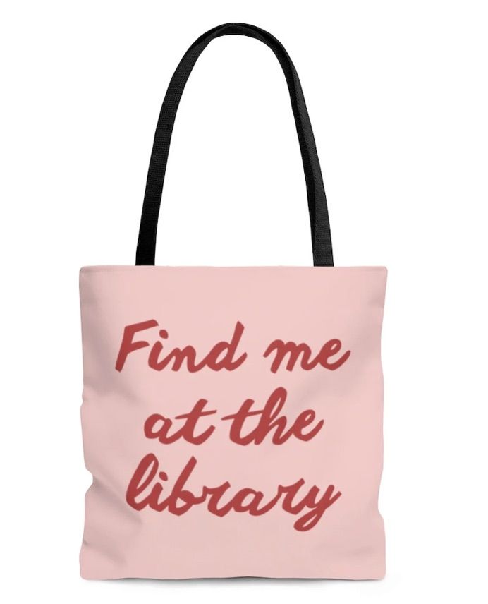 Image of a pink tote bag with red writing that says "find me at the library." 