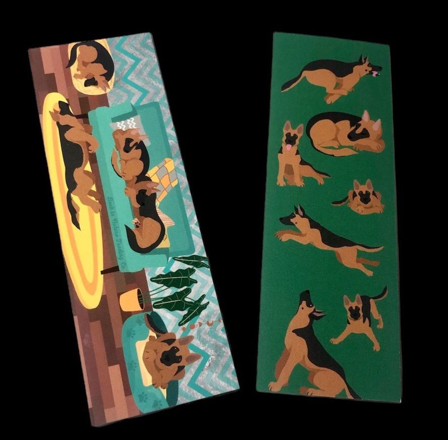 Image of both sides of a double sided bookmark featuring German shepherds. 