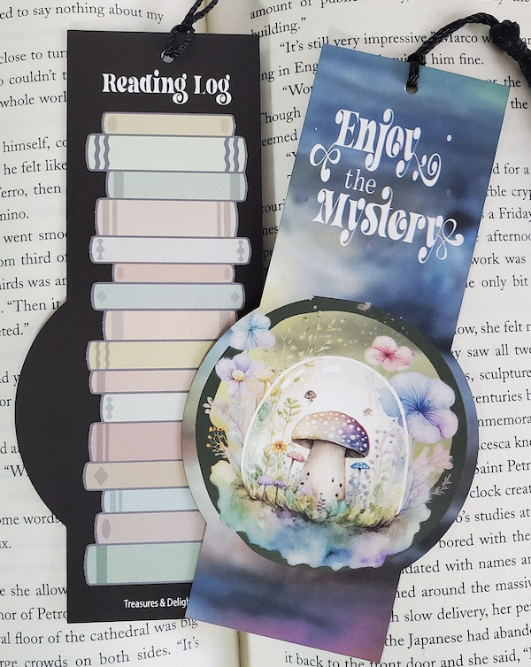 an illustrated bookmark with a pretty mushroom design on one side that says 