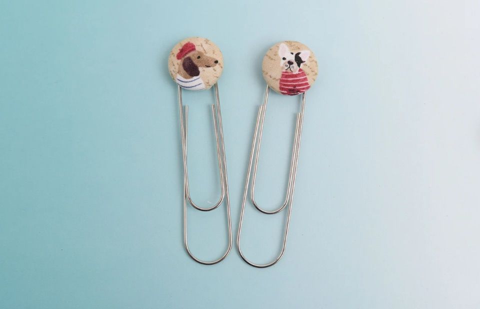 Set of two paperclip bookmarks featuring dogs wearing french attire. 