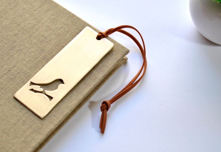 Image of a bronze bookmark featuring a sparrow. 