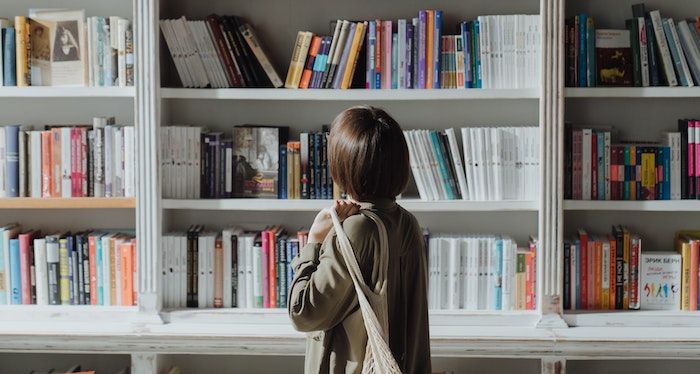 a photo of someone browsing bookshelves