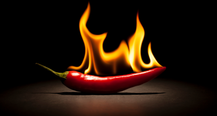 an image of a chili pepper on fire