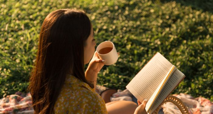 Image of a person reading outside