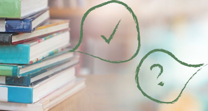 Image of a stack of library books with a bubble question mark