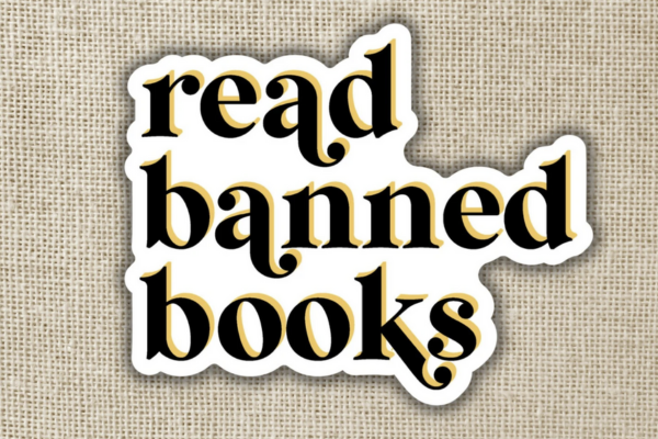 white sticker with black text saying "read banned books"