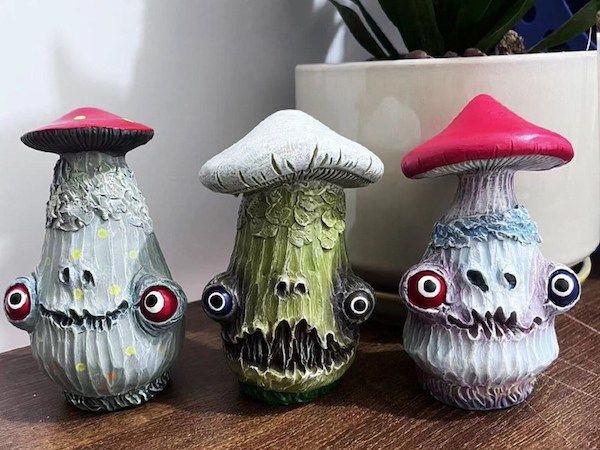 resin sculptures of mushrooms with fun creepy faces by StatueGallery