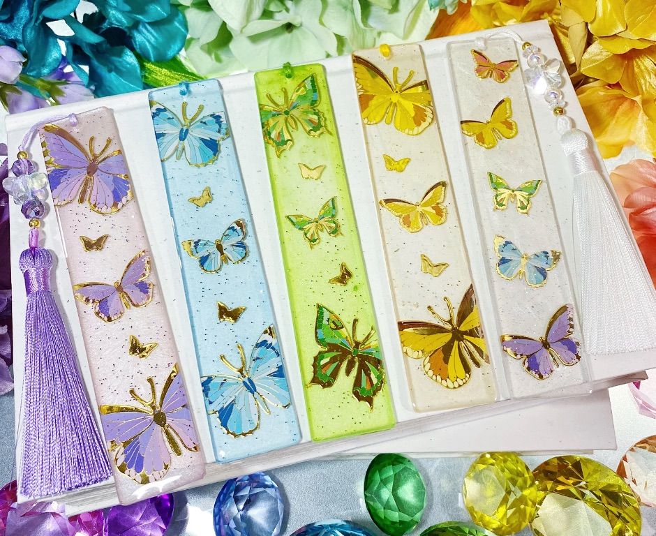 Image of five different colored butterfly bookmarks. 