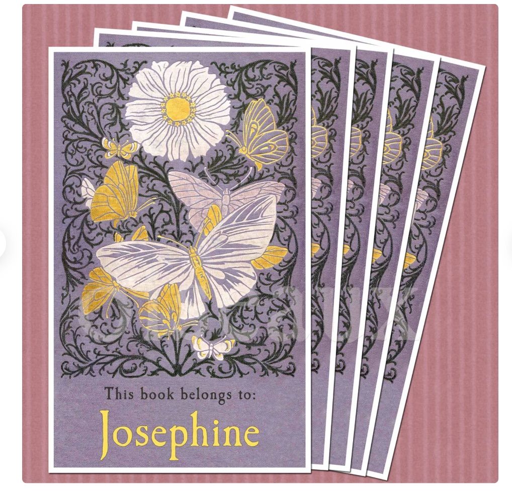Image of a pile of purple book plates featuring butterflies.