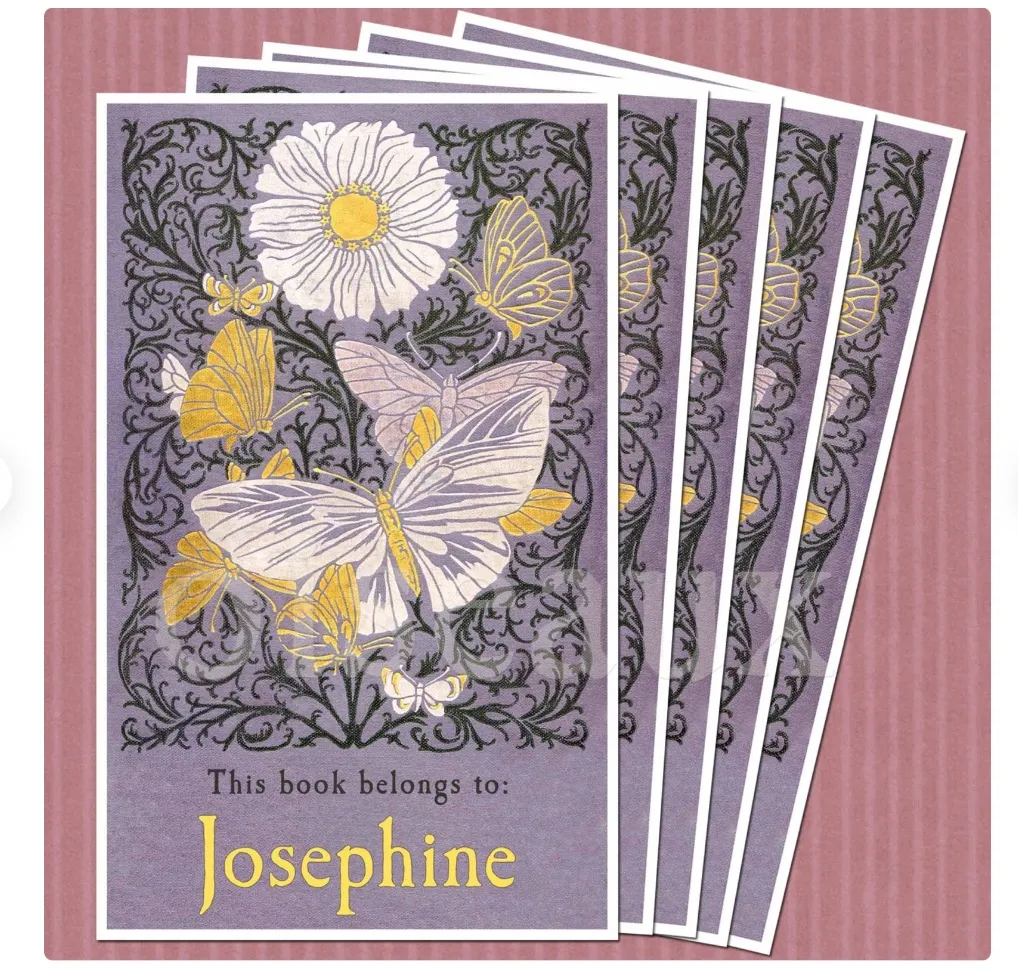 Image of a pile of purple book plates featuring butterflies.