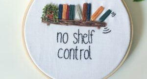 embroidery pattern of the words no shelf control beneath a single shelf containing books and a potted plant