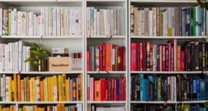 bookshelf arranged in rainbow pattern