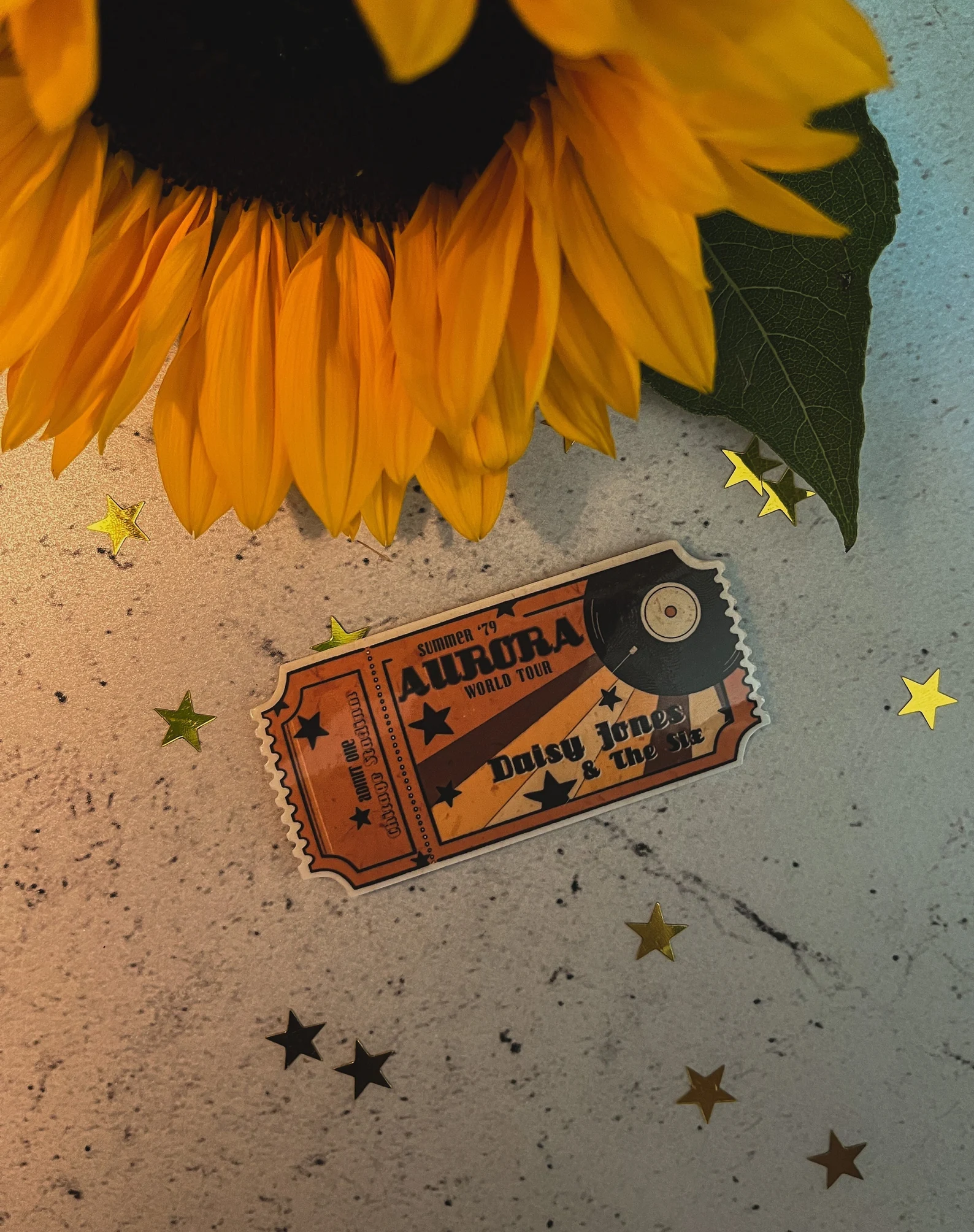 A vinyl sticker in the shape of an old style ticket for the Aurora tour
