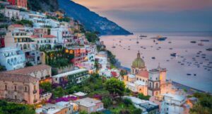 a coastline dotted with colorful buildings in Positano, Italy
