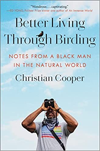 cover of Better Living Through Birding: Notes from a Black Man in the Natural World by Christian Cooper; photo of author, a Black man, holding up binoculars in front of a blue sky