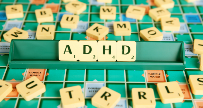a photo of scrabble tiles spelling out ADHD