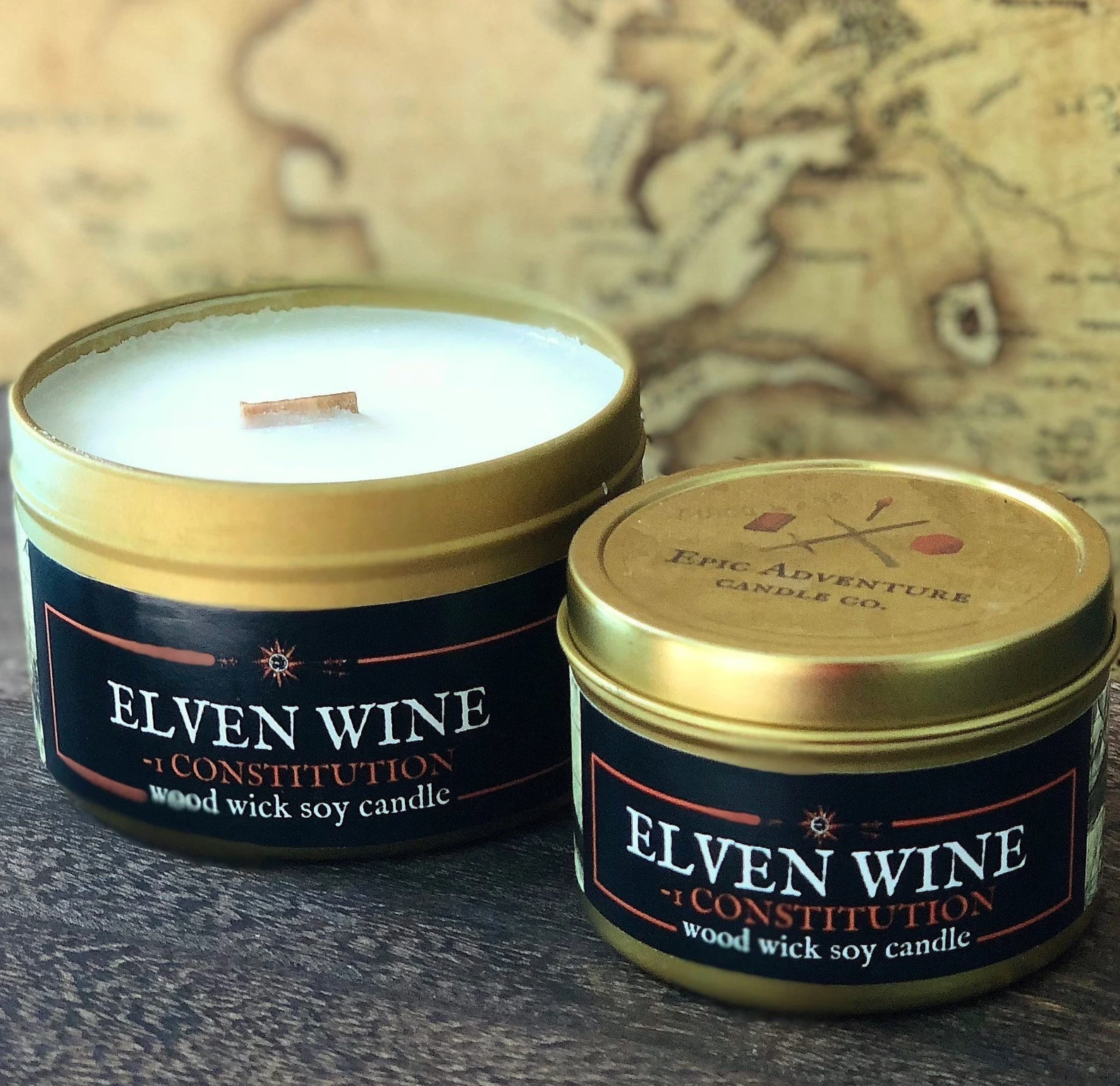 Two golden candle tins, one open the other closed with the label elven wine.