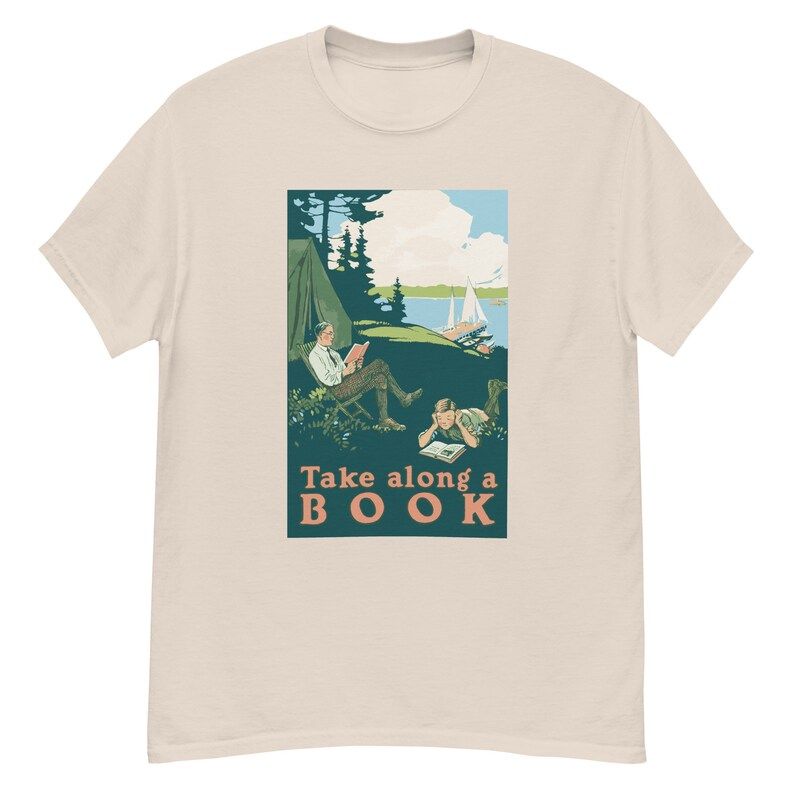 An off-white t-shirt with a vintage image of a man and a boy camping with the phrase "take along a book"
