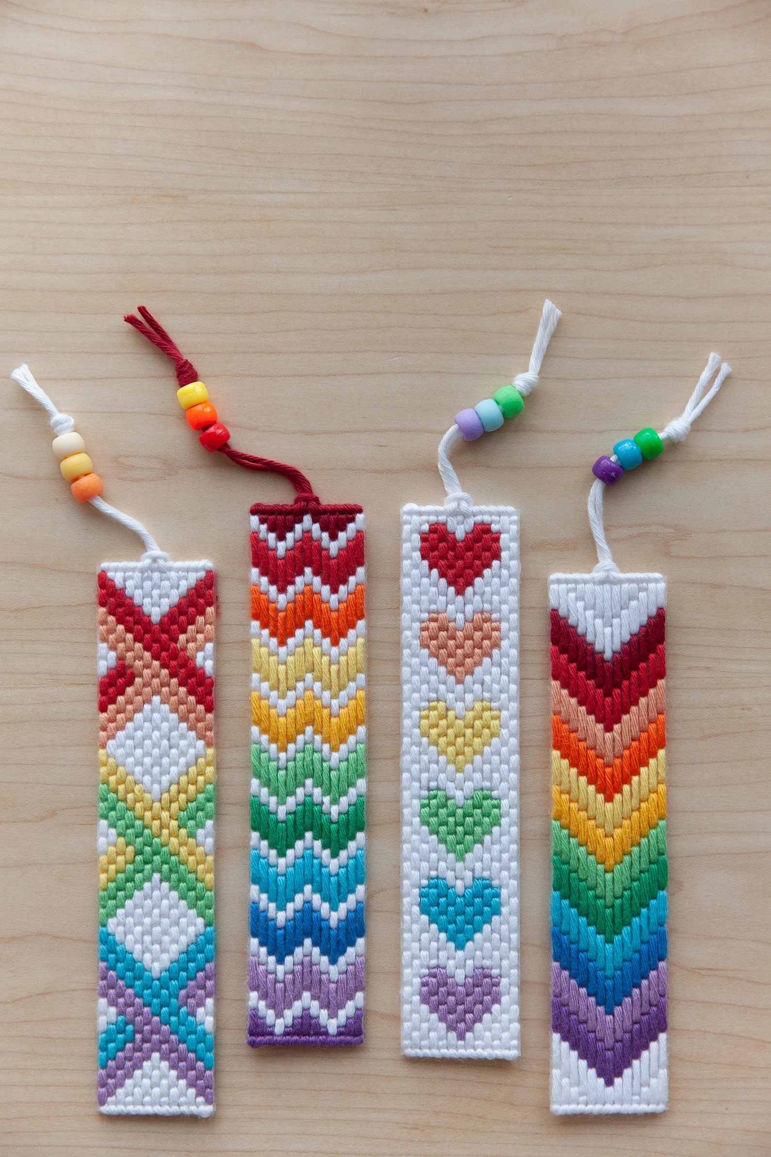 Image of four pride bookmarks done in cross stitch. 