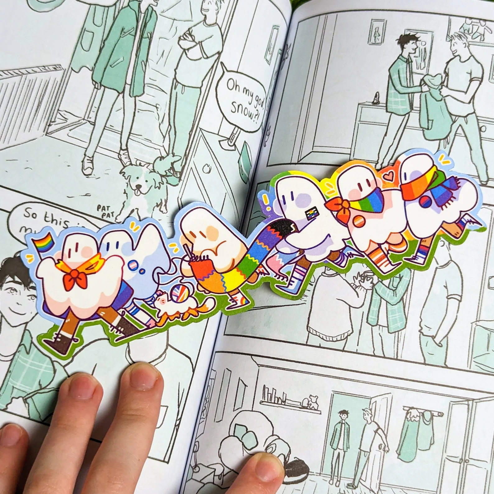 Image of a bookmark featuring ghosts in a pride parade..