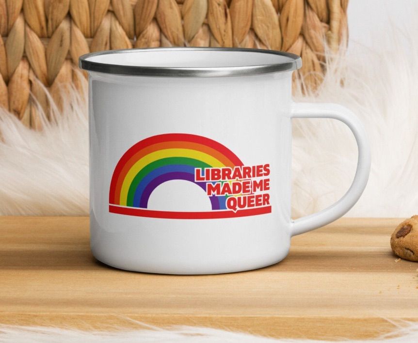 Image of a white camper mug with a rainbow and text reading 'libraries made me queer."