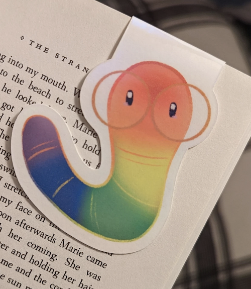 magnetic bookmark of an illustrated bookworm in rainbow colors