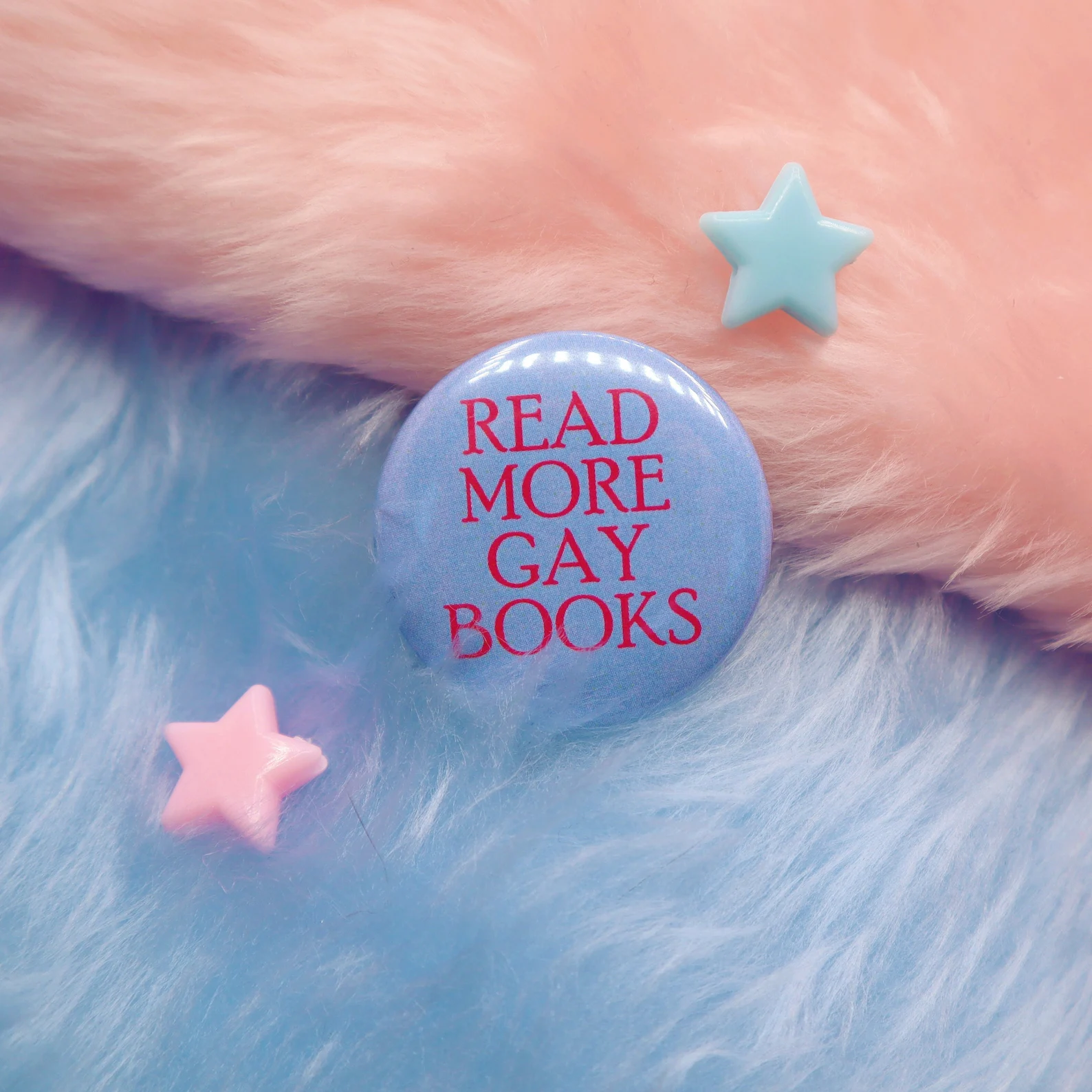 Image of a purple pin with the pink text "read more gay books."