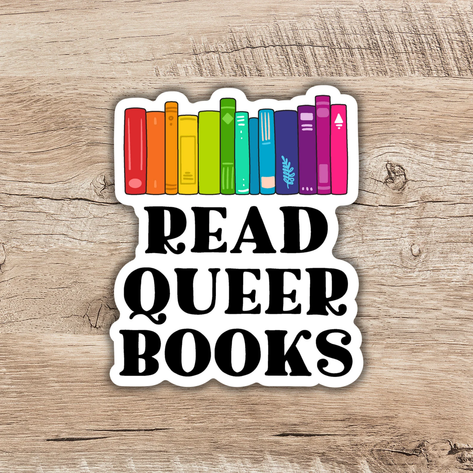 Image of rainbow book spines with "read queer books" underneath. 