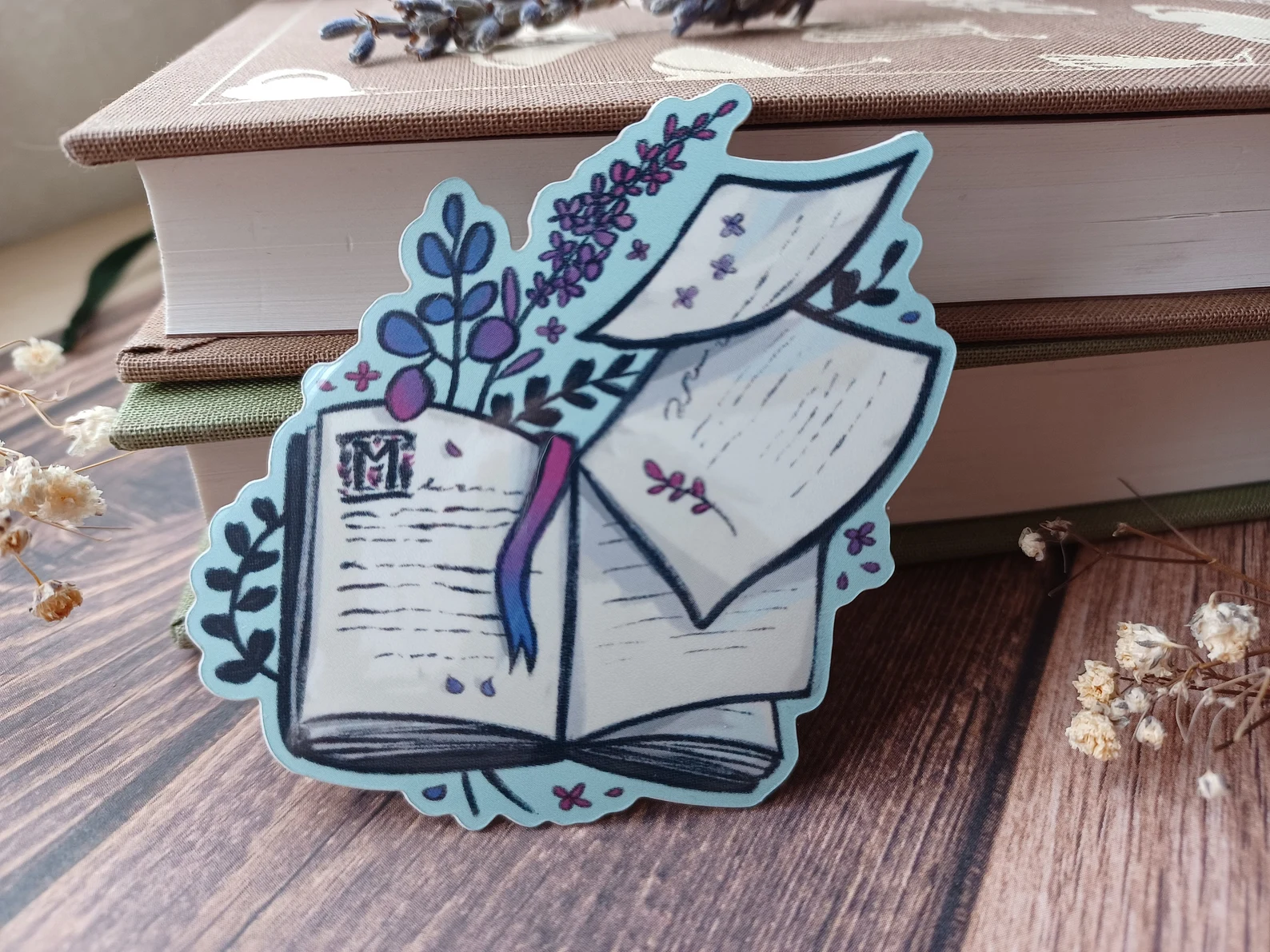 Image of an open book with lavender sprigs.