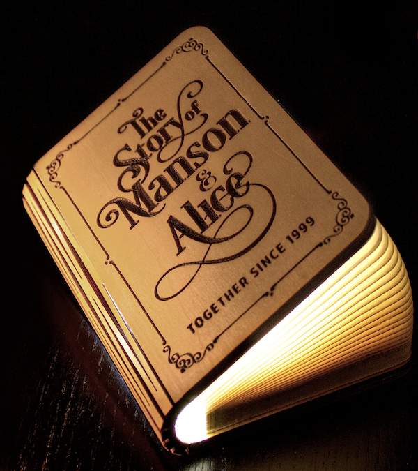 a wooden lamp shaped like a book that can have the cover engraved