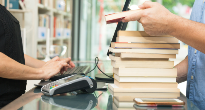 a photo of a stack of books being bought