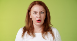 a photo of a white woman with red hair making a horrified or disgusted expression