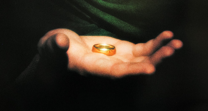 cropped Lord of the Rings poster showing a hand holding the one ring