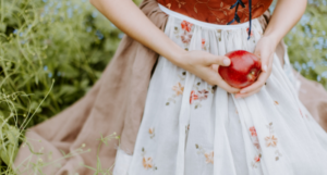 a photo of a woman holding an apple