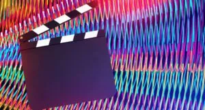 Image of a clapboard with a colorful background