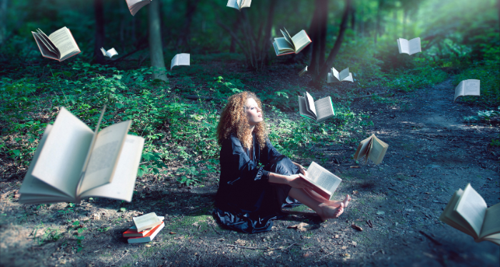 a photo of someone reading in the woods with floating books around them