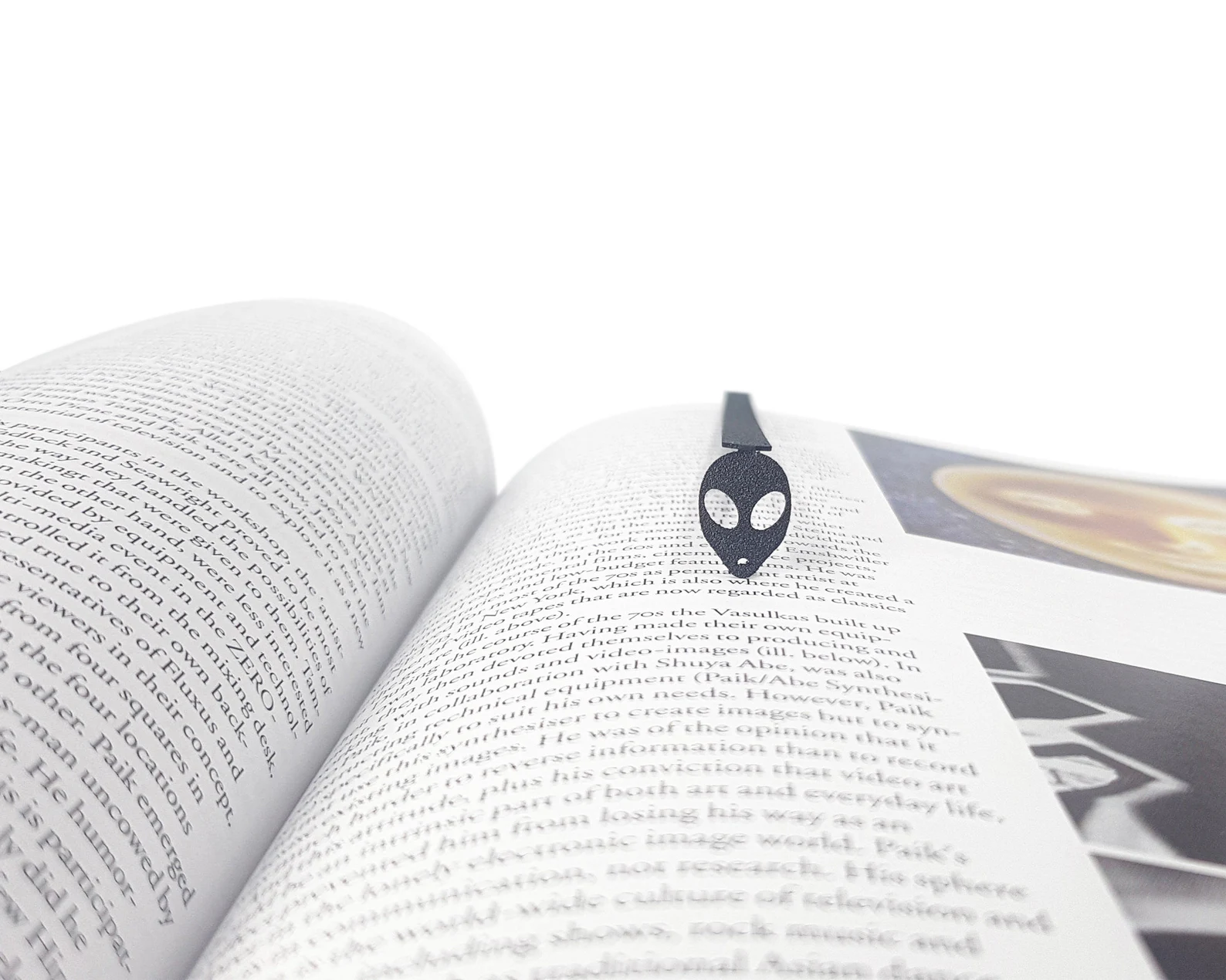 Image of a metal bookmark with an alien head. 