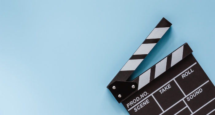 a photo of a movie clapper board against a blue background