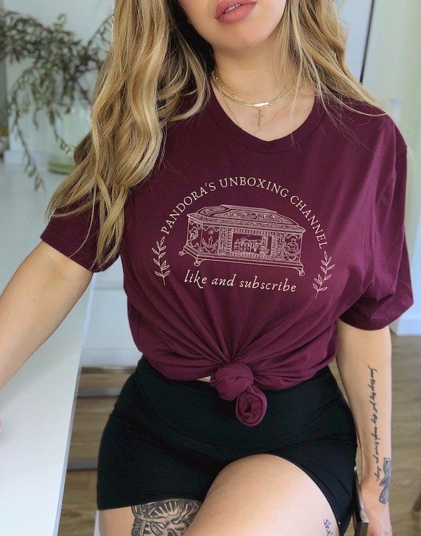 burgundy tshirt with text that reads "Pandora's Unboxing Channel, like and subscribe" around an image of an ornate box