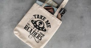tote bag with the words "take me to your reader."